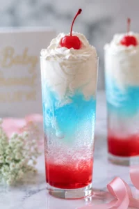 Italian Cream Soda with syrup layers, cream swirl, and cherry on top, pastel baby shower style.
