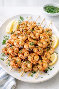 Overhead shot of grilled shrimp skewers marinade ingredients being whisked together.