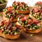 Toasted bruschetta topped with black-eyed peas, greens, peppers, and crispy bacon.