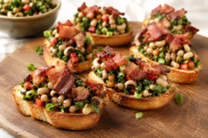 Toasted bruschetta topped with black-eyed peas, greens, peppers, and crispy bacon.